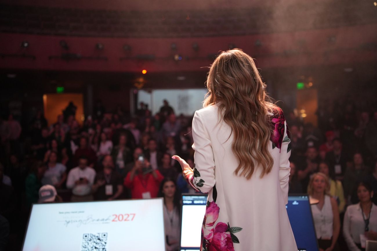 Spring speaking to a full theater