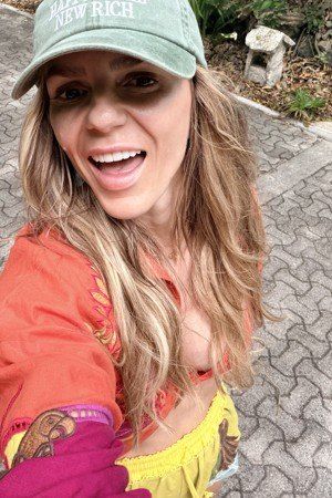 Spring in a green cap, laughing at the camera